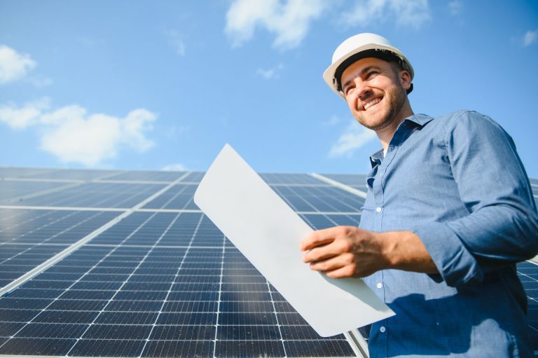 construction worker standing in front of solar panels